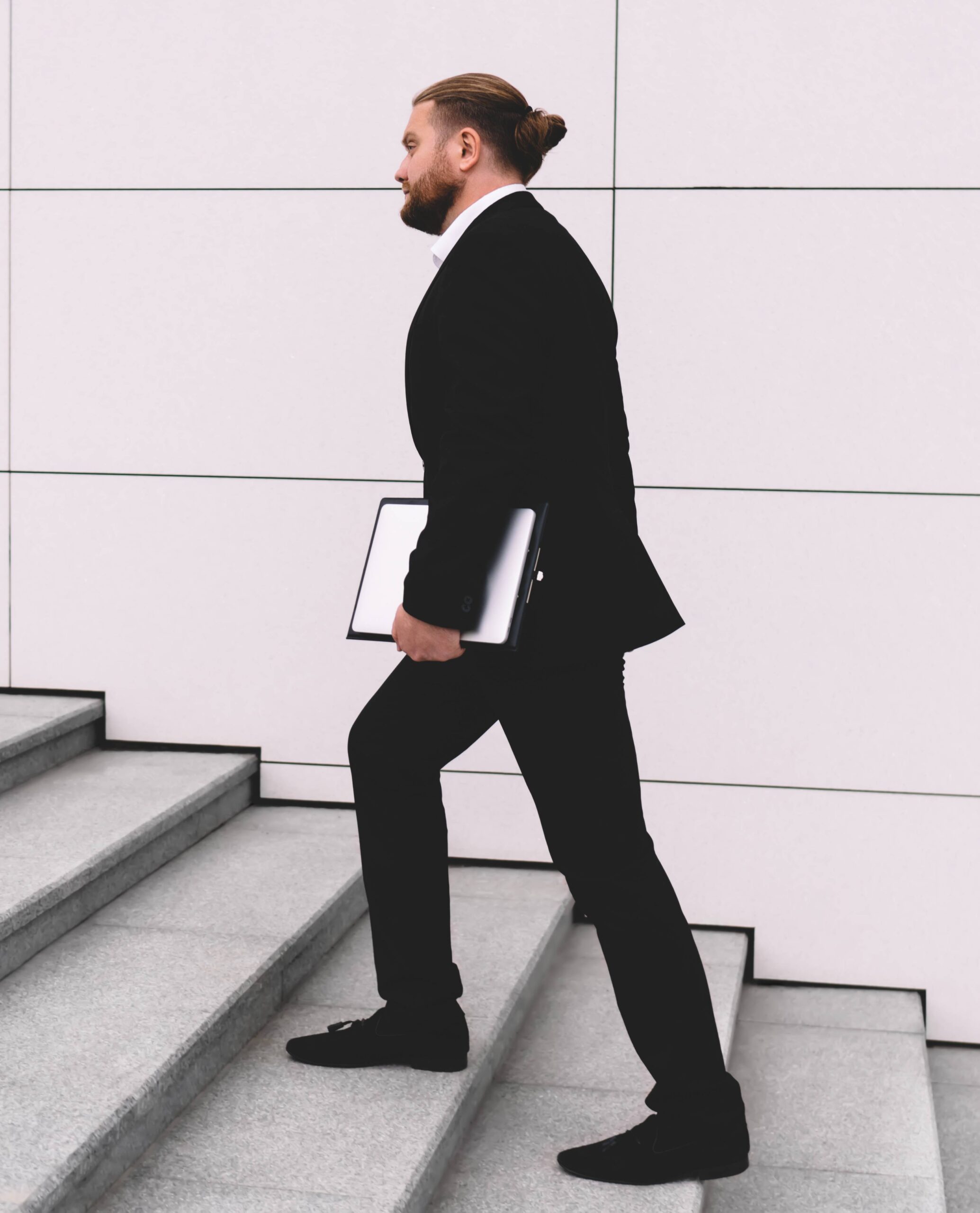 businessman-walking-upstairs-on-street-2024-05-02-18-10-18-utc (2)