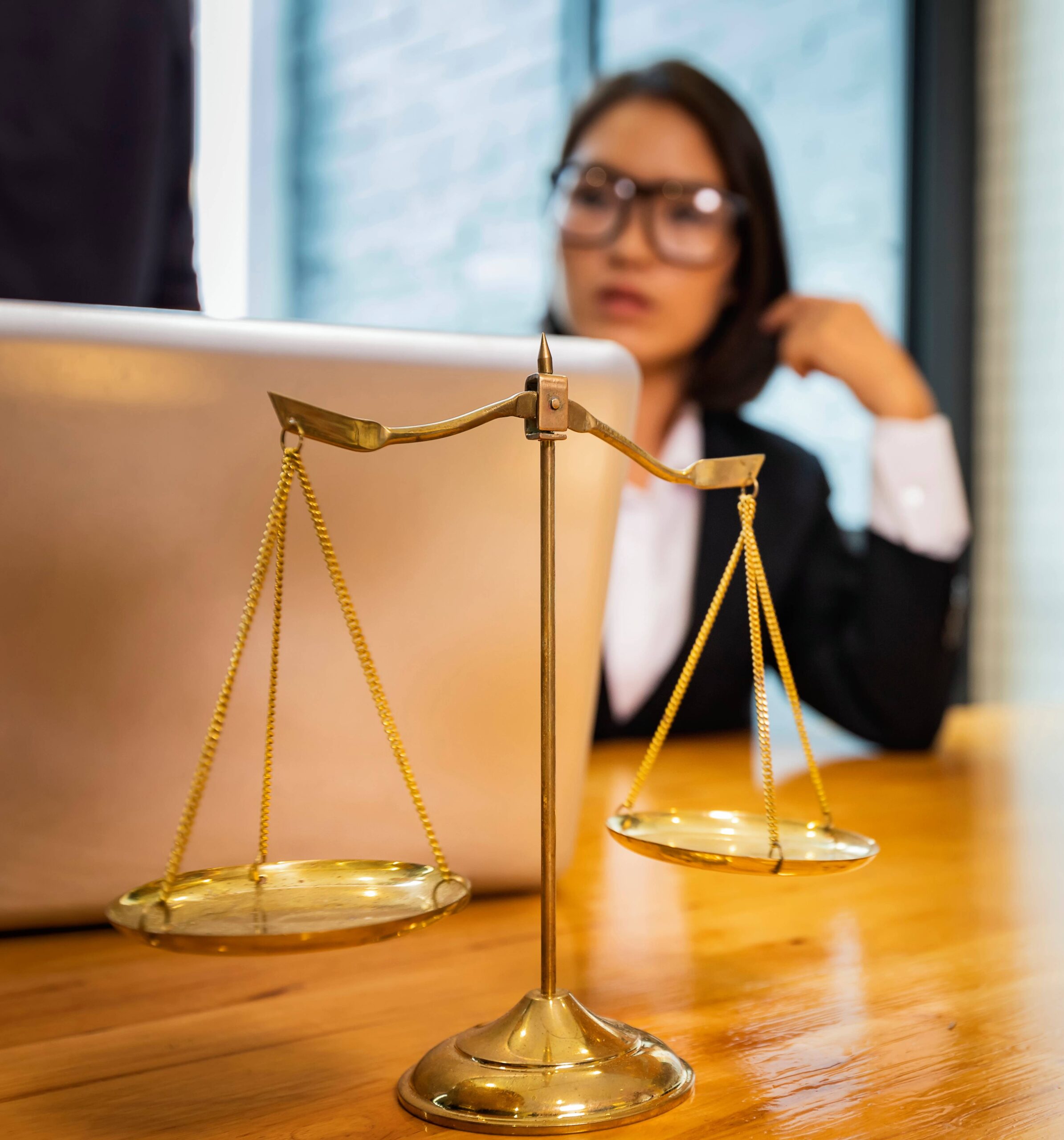 scales-and-lawyer-working-on-a-laptop-lawyer-offi-2023-11-27-05-03-05-utc (1)